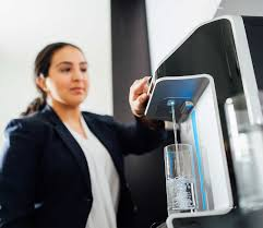 Professional woman using office water filtration system